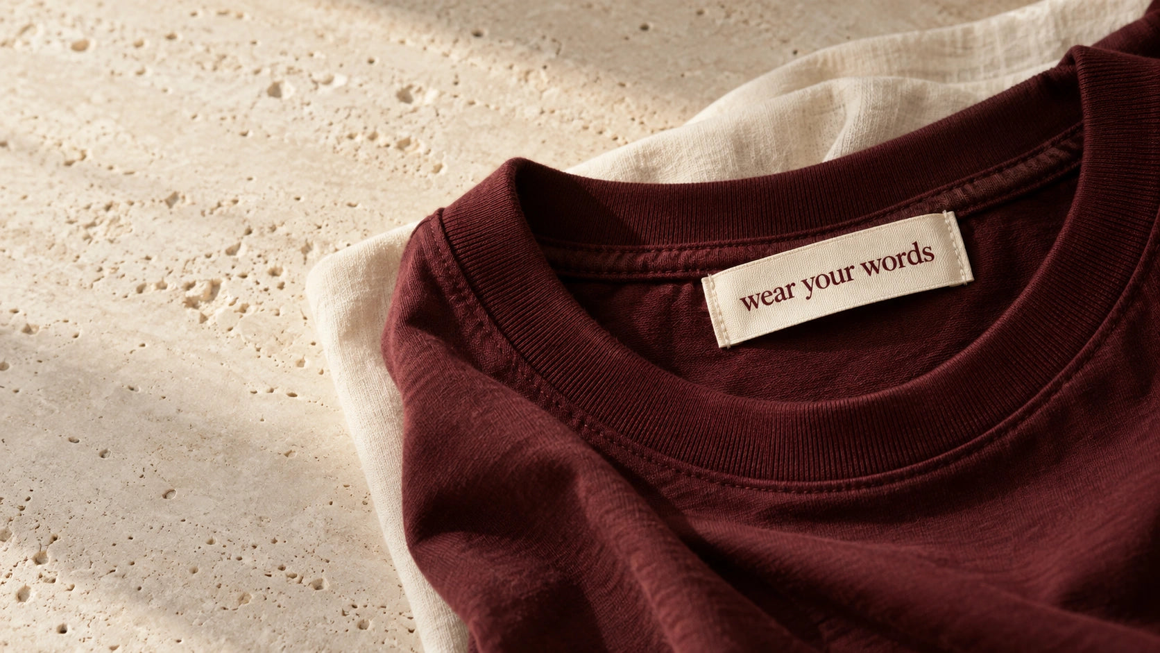 A close look at rich oxblood cotton, ribbed collars and the Wear Your Words label